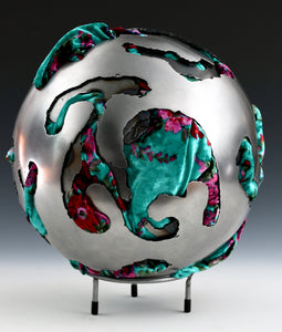 Steel Sphere with Velvet Fabric  Diameter: 12" (30 cm) - Thickness: 1/8" (3 mm)  Fabric: Velvet - teal with fuchsia and crimson highlights  Style: Enclosed  Steel is layered 1 to 3 thickness below the surface throughout the piece  Weight: 15 lbs (7 kg)